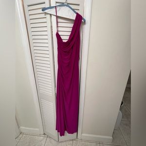 This fuchsia colored long dress is perfect for any occasion. It is one shoulder.